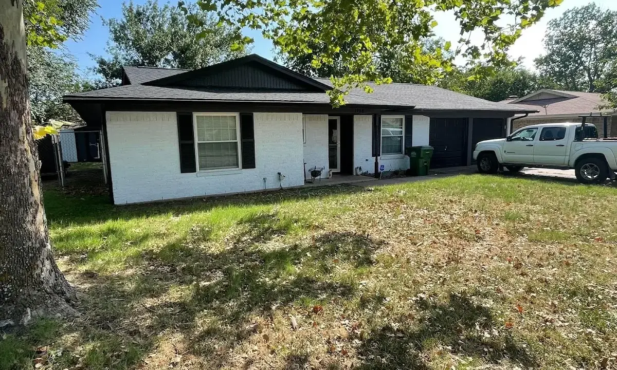 Professional roofing crew working on a residential roof in Essex Junction